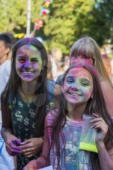 Lviv, Ukraine - August 30, 2015: Girls  have fun during the festival of color in a city park in Lviv.