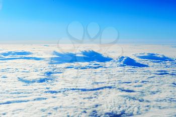 Blue sky and clouds. Plane view above the earth, can be used for background