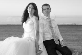 Beautiful wedding couple- bride and groom at the beach. Just married. Black and white