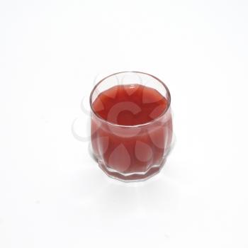 Juice in glass isolated on white.
