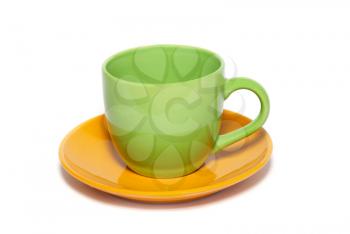 Colored teacup and saucer isolated on white.