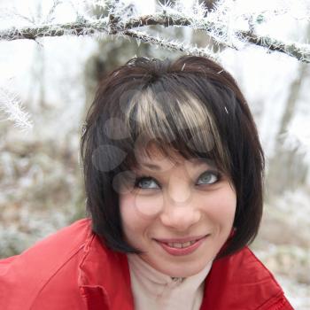 Pretty winter girl in the snow forest