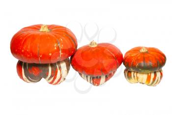 Three red pumpkins isolated on white.