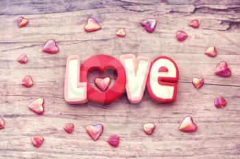 Word love with heart on wooden background
