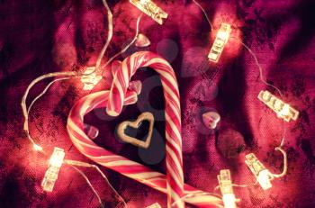The heart of lollipops among the garlands on a dark background. Valentine's photo,