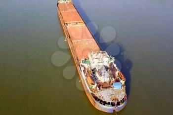 A cargo barge floats along the river. Cargo ship