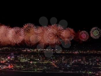 Festive salute in the night sky. Salute over the city the megalopolis. Explosions of fireworks.