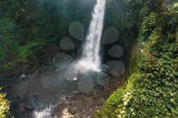 Waterfall in the rain forest. People are swimming in the waterfall. Waterfall beauty of nature.