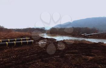 Construction of a pipeline across the river. Difficulties in laying pipelines. Pipes of a gas pipeline, construction and laying of pipelines for transportation of gas and oil.