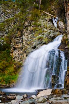 Breathtaking Waterfall in rocky Altai Mountains. Mountain stream running over rocks. Siberia, Russia