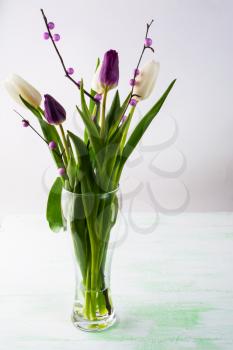 Decorated bouquet of fresh white tulips in a vase vertical. Flower frame. Flower background. Flower bouquet. Greeting card. Mothers day. Place for text. Copy space