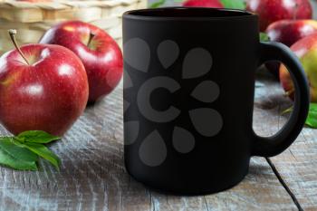 Black coffee mug mockup with apples. Empty mug mockup for product presentation. Coffee cup mockup.