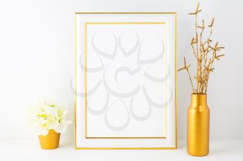 Frame mockup with ivory hydrangea in the golden flower pot. Poster white frame mockup. Empty white frame mockup for presentation artwork.