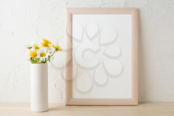 Frame mockup with white and yellow chamomiles in vase. Poster white frame mockup. Empty white frame mockup for presentation design.