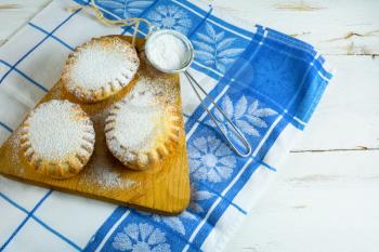 Small confiture pie on the cutting board. Jam pie. Small pie. Pie. Sweet pastry. Sweet dessert