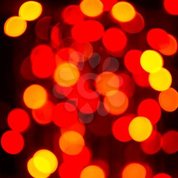 Yellow and red lightbulb, square. Bokeh background