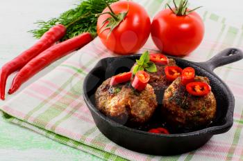 Beef meatballs with chili pepper served in skillet. Grilled bbq meatloaf. Barbecue meatballs. 