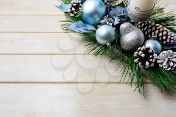 Christmas background with holiday decorated candleholder and blue ornaments. Christmas decoration with pine cones. Christmas greeting background. Copy space.
