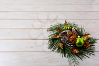 Christmas greeting with pine branches and golden cones. Christmas centerpiece with golden decor. Christmas party background. Copy space.