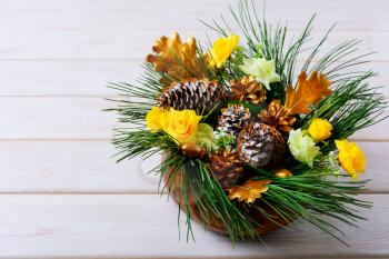 Christmas table decoration with pine branches and golden cones. Christmas centerpiece with golden decor. Christmas party background. Copy space.