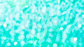 Mint green bokeh defocused background. Bokeh blurred texture.