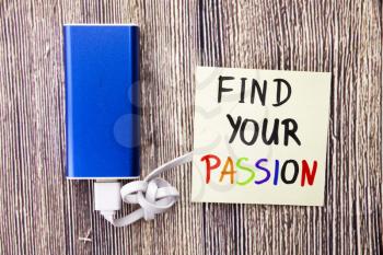 Find your Passion handwritten on sticky white color note paper in different colors. Power bank of blue color with White cable and on retro old wooden background. Motivational Concept.