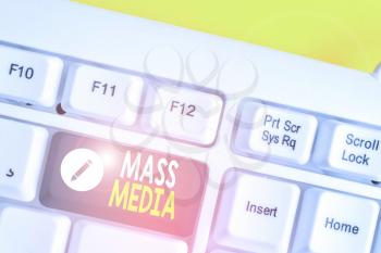 Writing note showing Mass Media. Business concept for Group showing making news to the public of what is happening White pc keyboard with note paper above the white background