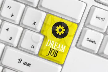 Conceptual hand writing showing Dream Job. Concept meaning An act that is paid of by salary and giving you hapiness White pc keyboard with note paper above the white background