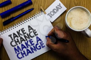 Text sign showing Take A Chance Make A Change. Conceptual photo dont lose opportunity to reach bigger things Man holding marker notebook clothespin reminder wooden table cup coffee