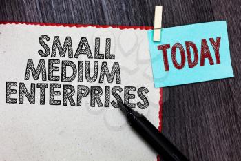 Writing note showing Small Medium Enterprises. Business photo showcasing companies with less than thousand workers White page red borders marker clothespin reminder wooden background