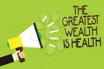 Conceptual hand writing showing The Greatest Wealth Is Health. Business photo showcasing being in good health is the prize Take care Man holding megaphone green background message speaking loud