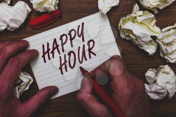Handwriting text writing Happy Hour. Concept meaning Spending time for activities that makes you relax for a while Man holding marker notebook page crumpled papers several tries mistakes