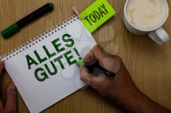 Conceptual hand writing showing Alles Gute. Business photo showcasing german translation all the best for birthday or any occasion Man holding marker notebook reminder wooden table cup coffee