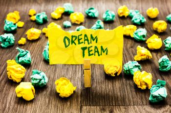 Writing note showing Dream Team. Business photo showcasing Prefered unit or group that make the best out of a person Clothespin holding yellow note paper crumpled papers several tries