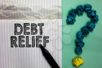 Conceptual hand writing showing Debt Relief. Business photo text partial or total remission of it especially those by countries Notebook marker crumpled papers question mark on green background