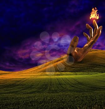 Surreal landscape with giant sculpture of hand and fire