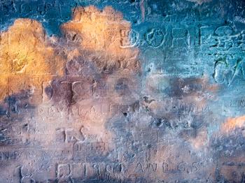 Engraved writings on colorful stone wall