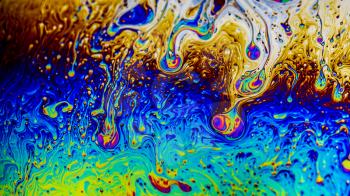 Extreme close-up of the colourful surface of a bubble