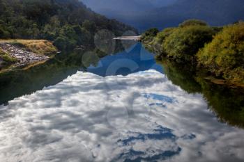 Clouds reflected in a river in New Zealand