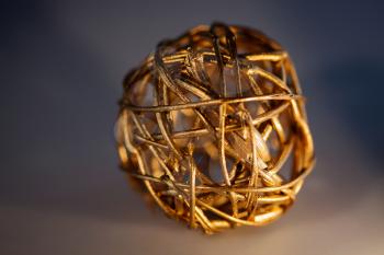 Sphere of pliable twigs painted gold to form a decorative object