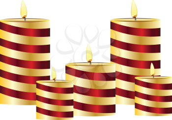 Set of lit candles in different sizes.