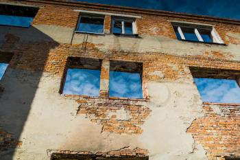 Old crumbling brick house, abandoned building background.