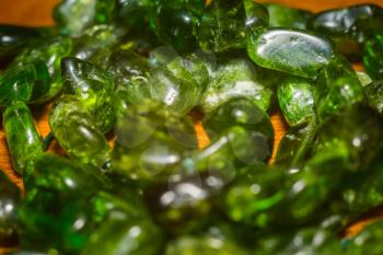 Dark green chrome diopside natural stone irregular beads close up.