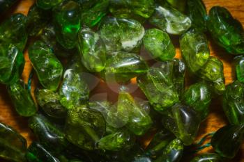Dark green chrome diopside natural stone irregular beads close up.