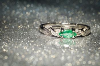 Fashion silver ring decorated with natural emerald stone.