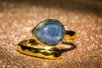 Fashion yellow gold ring with blue kyanite stone.