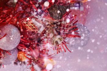 Colorful image with small red Christmas tree and falling snow.