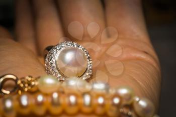 Luxury silver ring decorated with freshwater pearl of white color and diamonds.