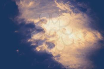 Dramatic sky with clouds, retro natural background with paper texture.