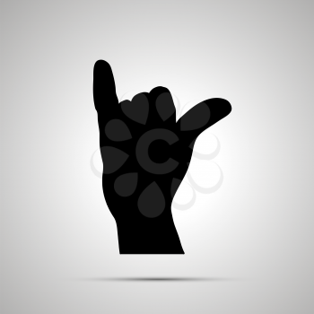 Black silhouette of hand in shaka gesture isolated on white